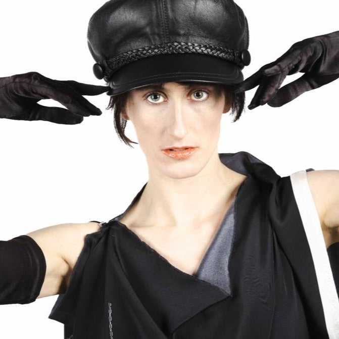 woman wears john lennon leather cap